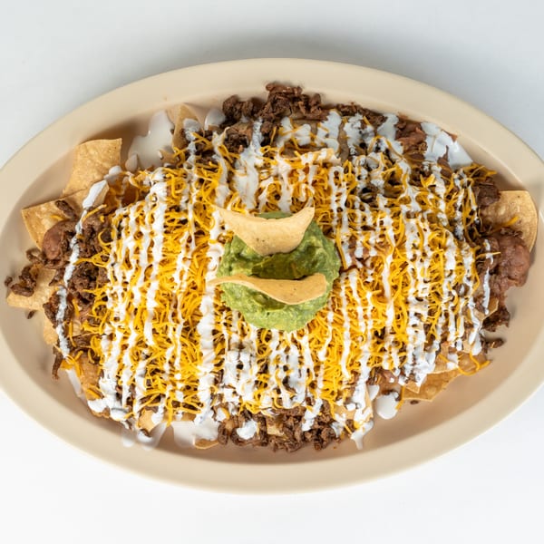 Juan Great Fiesta's nachos with beef, melted cheese, sour cream, and a dollop of guacamole.